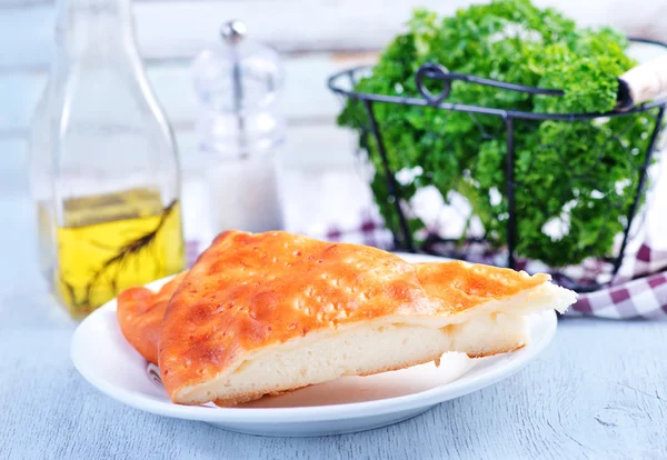Pie with cheese on white plate — Stock Photo, Image