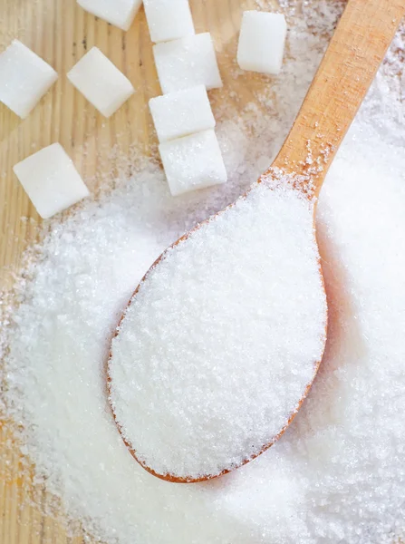 Sugar in wooden spoon — Stock Photo, Image