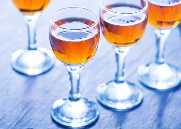 Cognac in glass and on  table — Stock Photo, Image