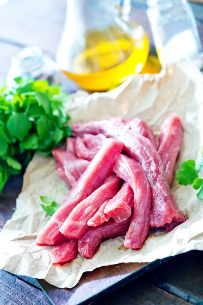 Raw meat on paper — Stock Photo, Image