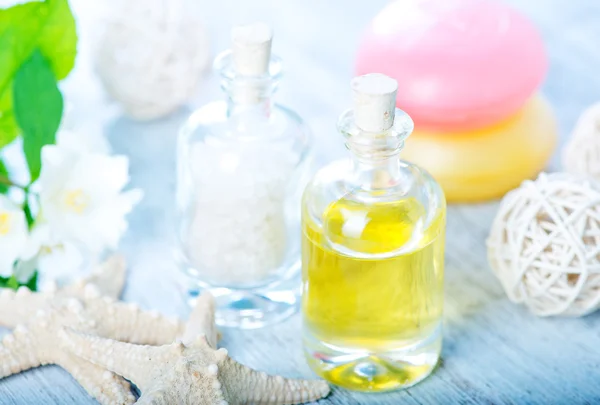 Oil in bottle and sea salt — Stock Photo, Image