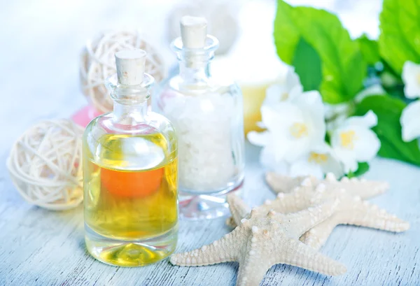 Oil in bottle and sea salt — Stock Photo, Image