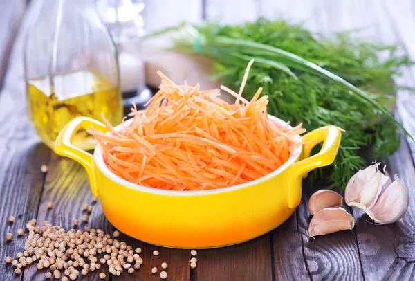 Carrot in bowl and on  table — Stock Photo, Image