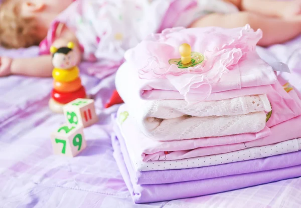 Baby clothes on the bed — Stock Photo, Image