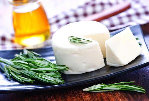 Cheese with rosemary on the plate — Stock Photo, Image