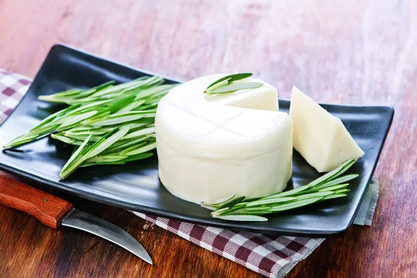 Cheese with rosemary on the plate — Stock Photo, Image