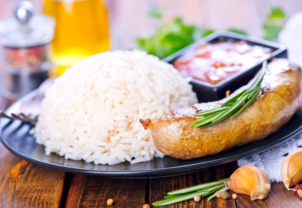 Boiled rice with sausages — Stock Photo, Image