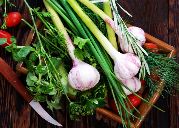 Garlic and green herbs — Stock Photo, Image