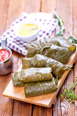 Dolmas with sauce and spices clipart