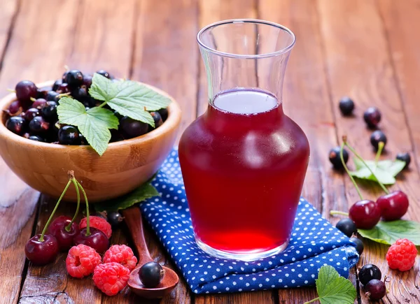 Compote from berries in jug — Stock Photo, Image