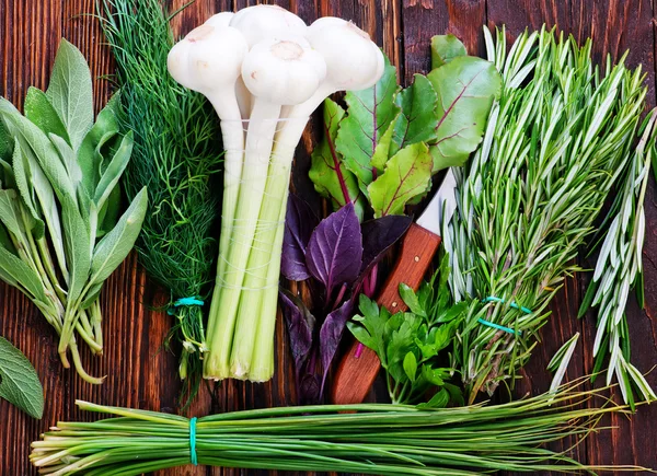 Green fresh herbs and garlic — Stock Photo, Image