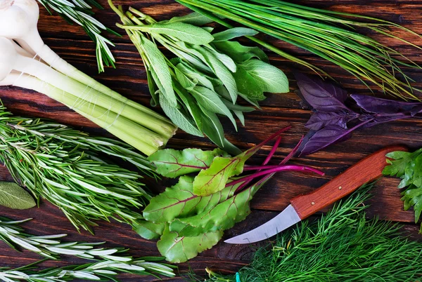 Green fresh herbs and garlic — Stock Photo, Image