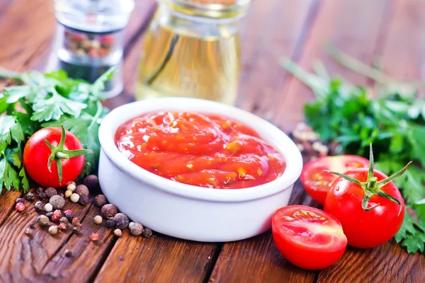 Tomato sauce with spices on table — Stock Photo, Image