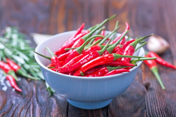 Chilli peppers and spices on table — Stock Photo, Image