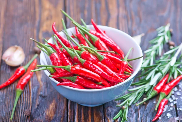 Chilli peppers and spices on table — Stock Photo, Image