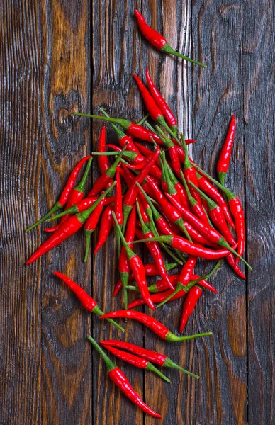 Hot chillies on table — Stock Photo, Image