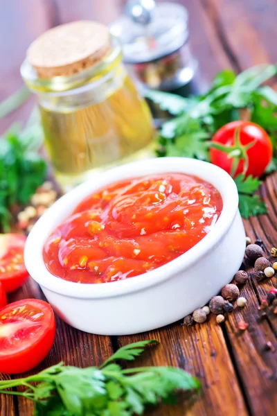 Tomato sauce with spices on table — Stock Photo, Image