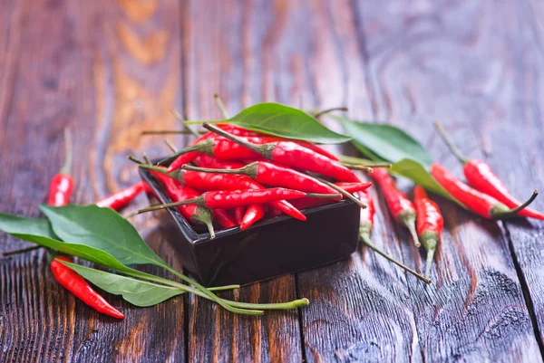 Hot chilliies on table — Stock Photo, Image
