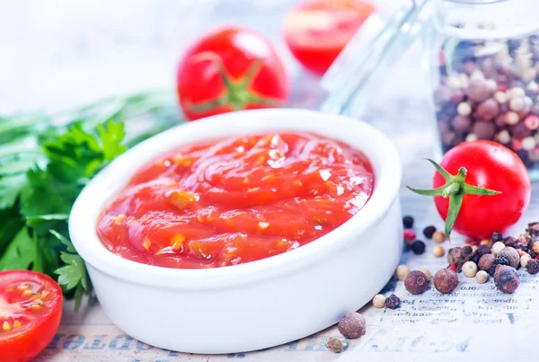 Tomato sauce with spices on table — Stock Photo, Image