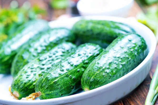 Cucumbers with spices on table — Stock Photo, Image