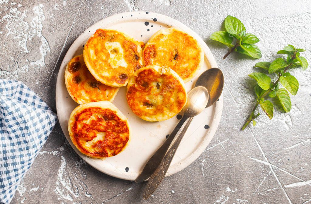 Cottage cheese pancakes, syrniki with blueberry on plate