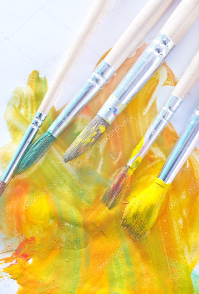 Brushes in yellow paint