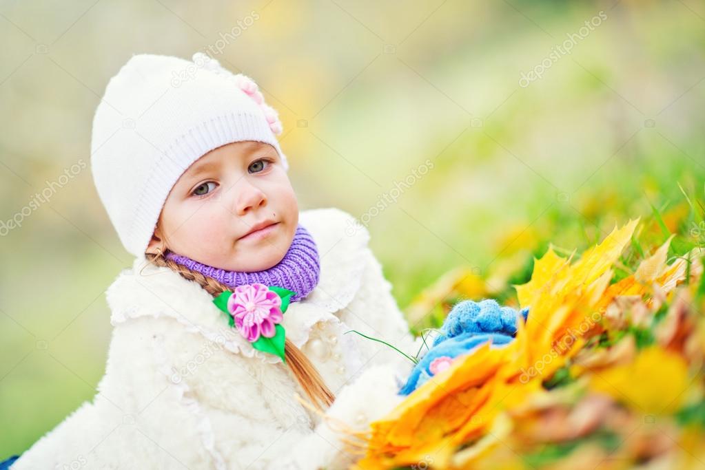 Little girl in autumn park