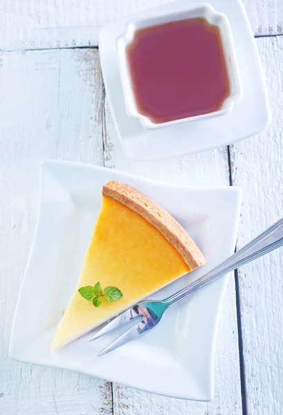 Söt cheesecake på plattan och te — Stockfoto