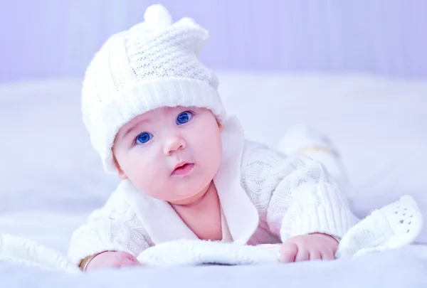 Baby in white knitted costume and hat — Stock Photo, Image