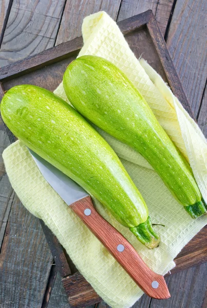 Raw zucchini on wooden tray — Stock Photo, Image
