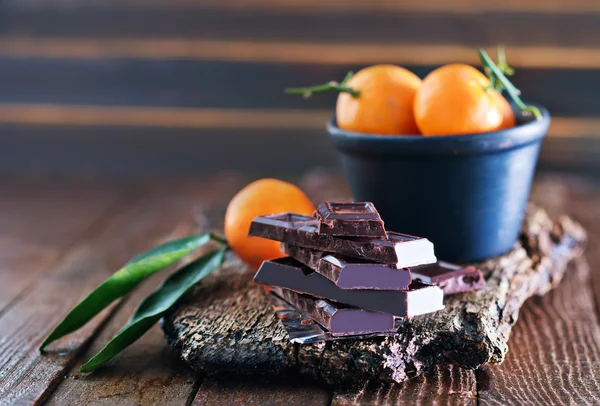 Chocolate and tangerines — Stock Photo, Image