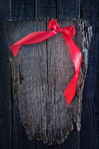 Red ribbon on wooden background — Stock Photo, Image