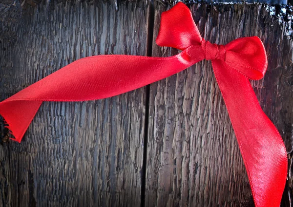 Red ribbon on wooden background — Stock Photo, Image