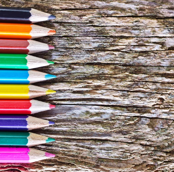 Color pencils on the wooden background — Stock Photo, Image