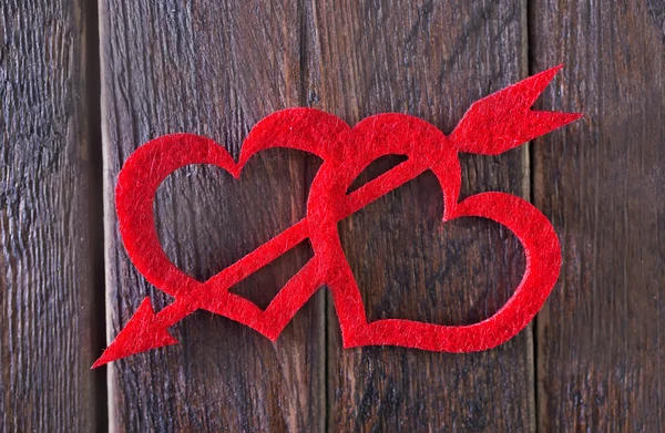 Red hears on the wooden table — Stock Photo, Image