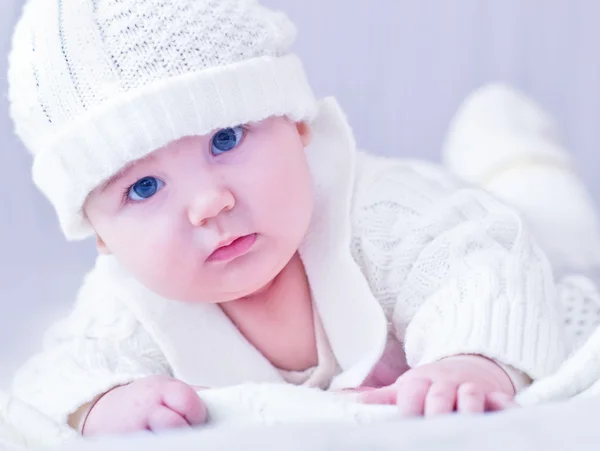 Baby in white knitted costume and hat — Stock Photo, Image