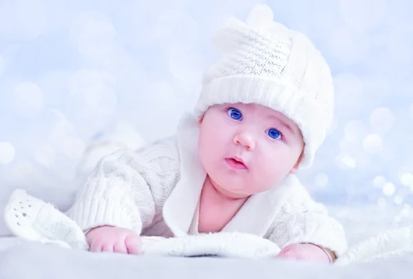 Baby in white knitted costume and hat — Stock Photo, Image