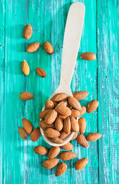 Almond in spoon — Stock Photo, Image