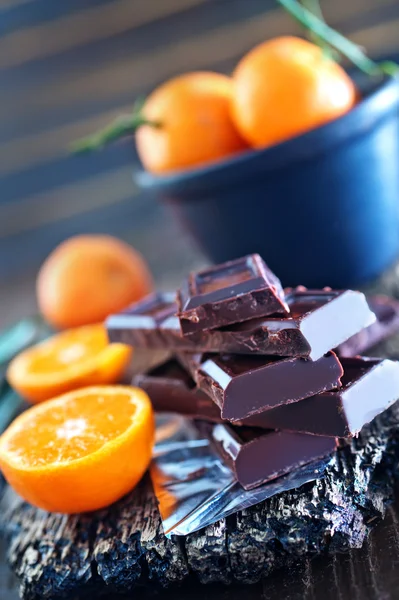 Chocolate and tangerines — Stock Photo, Image