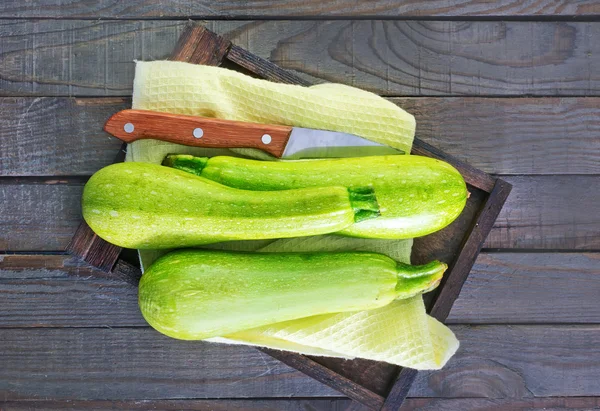 Raw zucchini on wooden tray — Stock Photo, Image