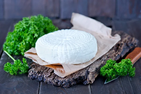 Round cheese on board — Stock Photo, Image