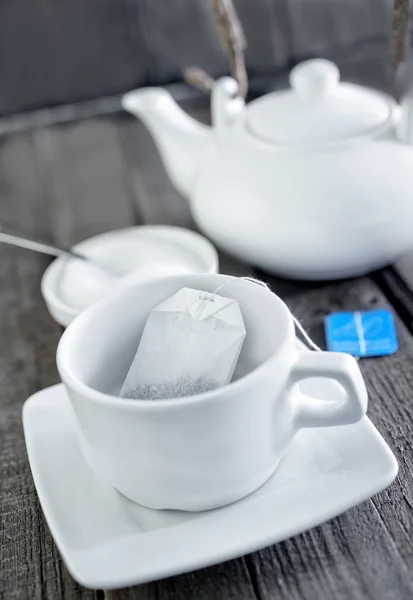 Cup for tea and tea in bag — Stock Photo, Image