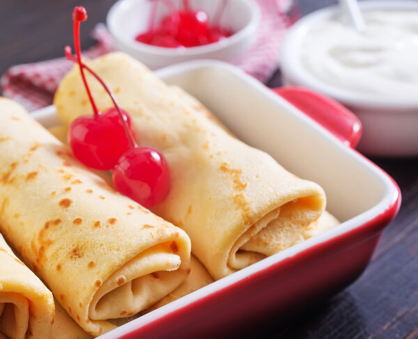 Pancakes with cherry in bowl