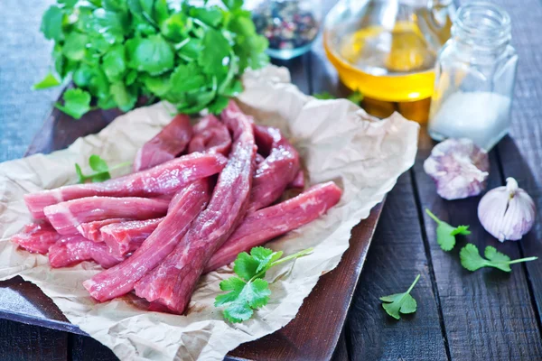 Raw meat and spice on paper — Stock Photo, Image