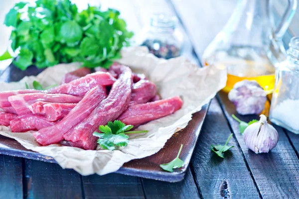 Raw meat and spice on paper — Stock Photo, Image