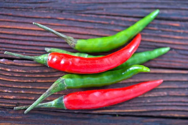 Chilli peppers on the wooden table — Stock Photo, Image