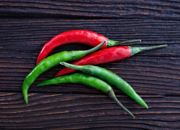 Chilli peppers on the wooden table — Stock Photo, Image