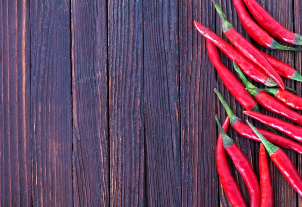 Chilli peppers on the wooden table — Stock Photo, Image