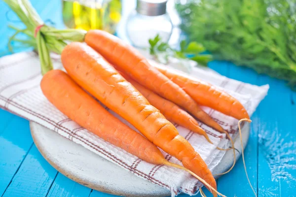 Raw carrot on board