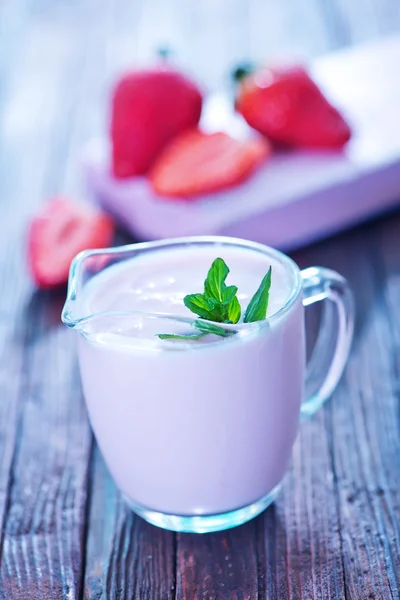 Strawberry yogurt in glass jug — Stock Photo, Image